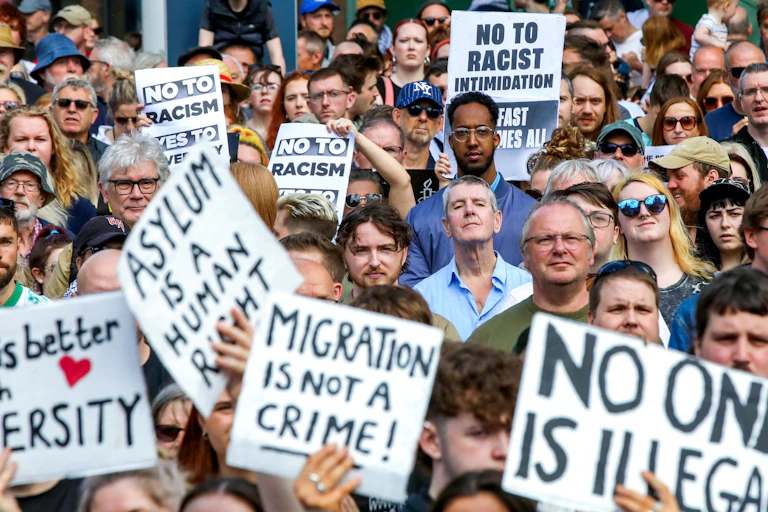 A group of people holding placards during a street protest