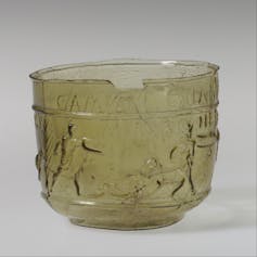 A glass cup showing gladiators fighting