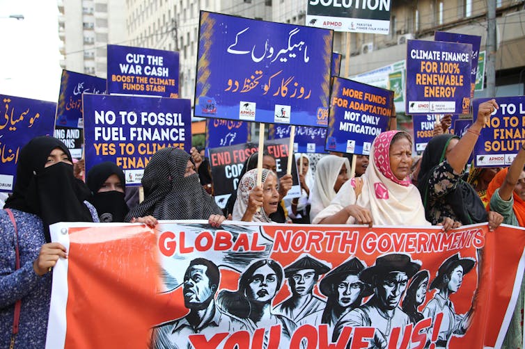 A march of women holding placards and a banner.