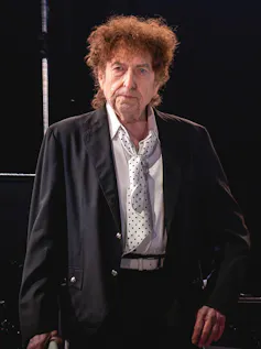 Dylan on stage in a suit