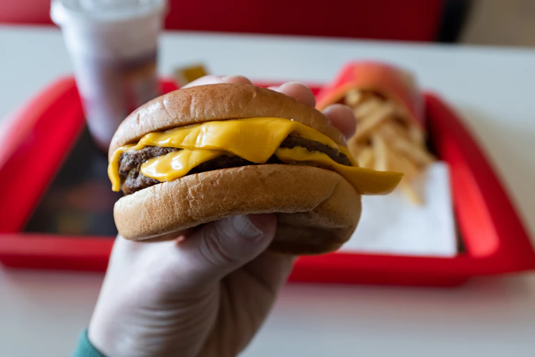 A fast-food hamburger is seen in close-up.