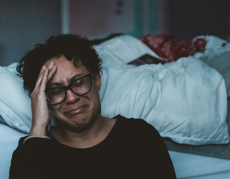 The woman cries.