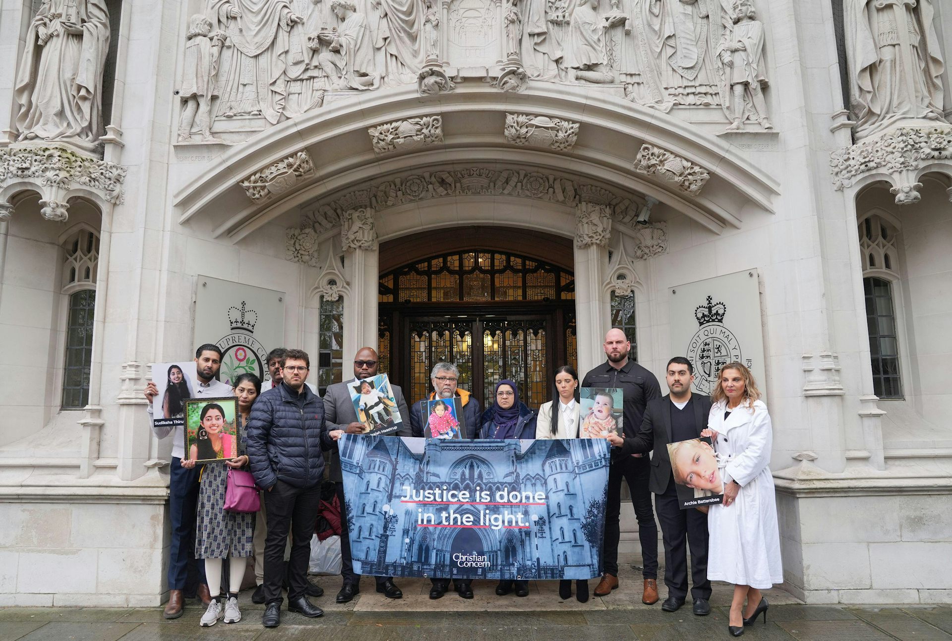 The family of Sudiksha Thirumalesh stand with another family outside the Supreme Court in London.