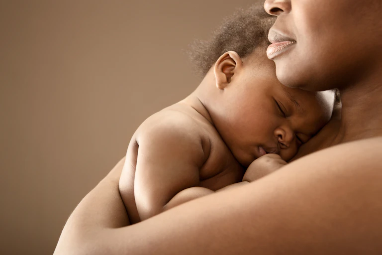 Woman holding a sleeping baby
