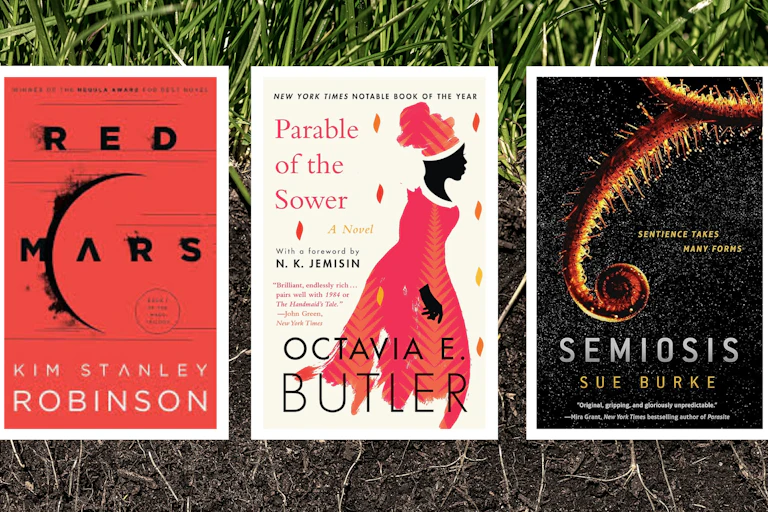 Three books on a backdrop of soil
