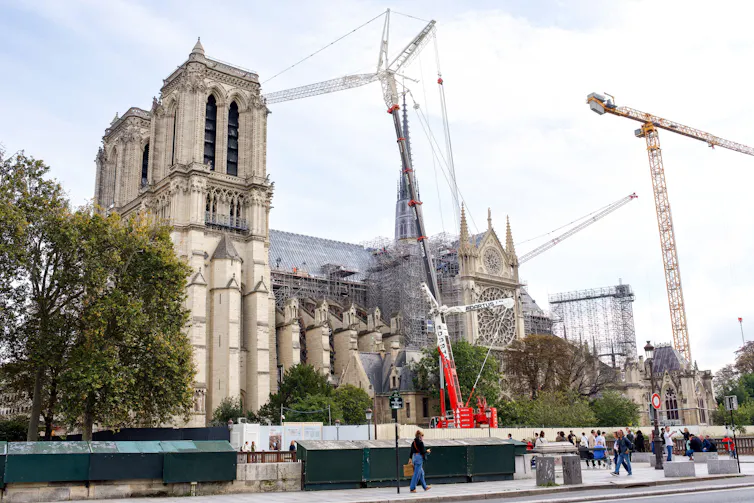 Notre Dame Cathedral in Paris surrounded by cranes.
