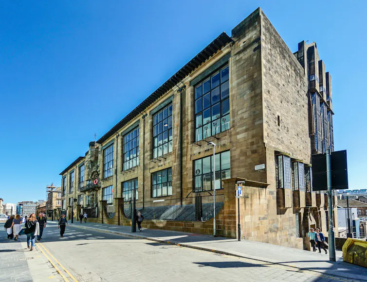 A stunning art nouveau building, Glasgow School of Art set against a vivid blue sky.