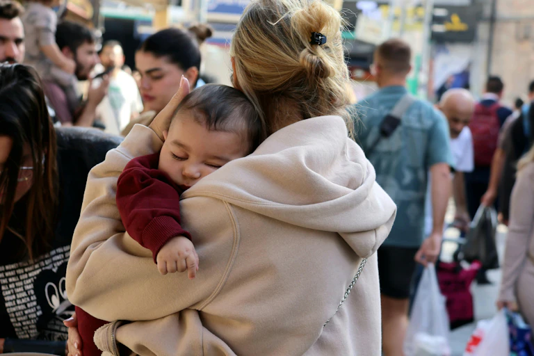 A woman holds her baby