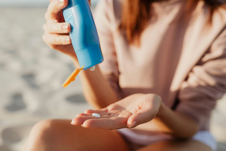 Woman puts sunscreen in her hand