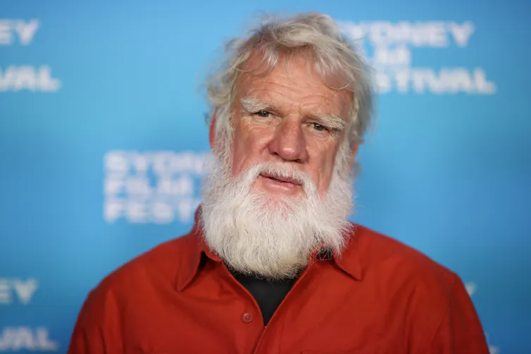 A white-haired, bearded man.
