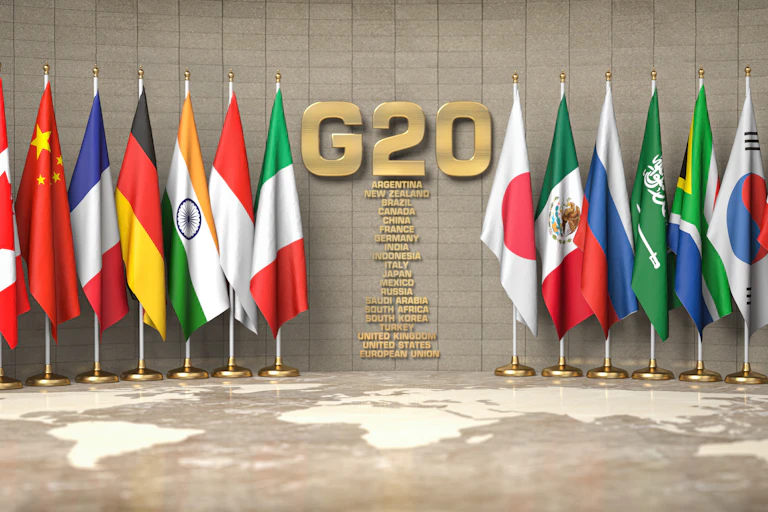 Row of flags of members of G20 Group of Twenty and list of countries in a conference room
