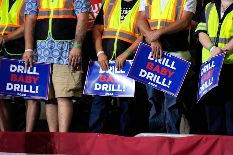 Trump supporters hold up signs reading 'exercise for baby'