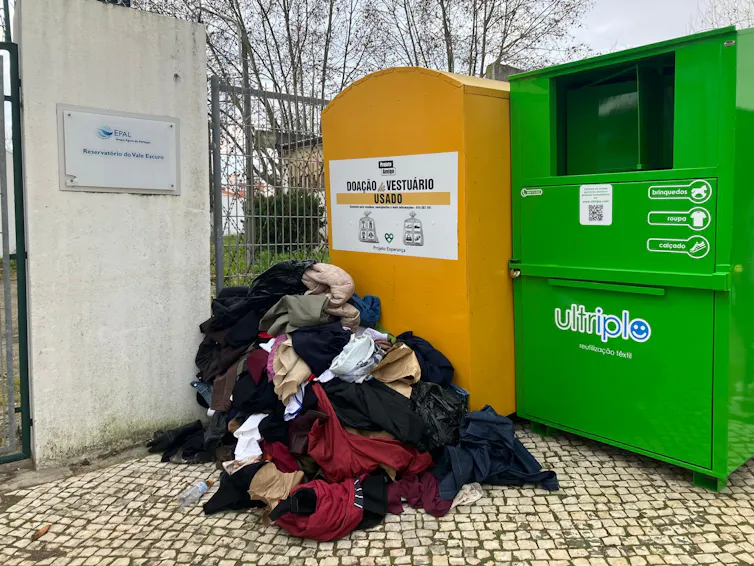 clothing waste next to bins