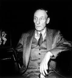 Black and white photo of Burroughs in a suit