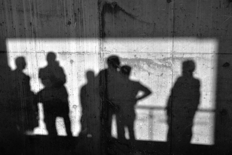 Images of people silhouetted on a concrete wall