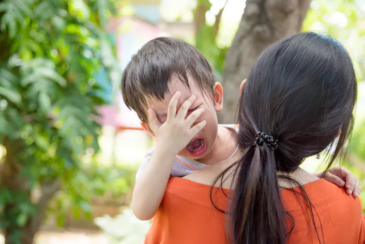 A boy cries at daycare dropoff