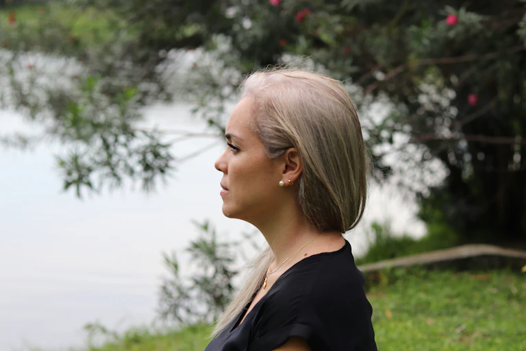Woman looks across lake