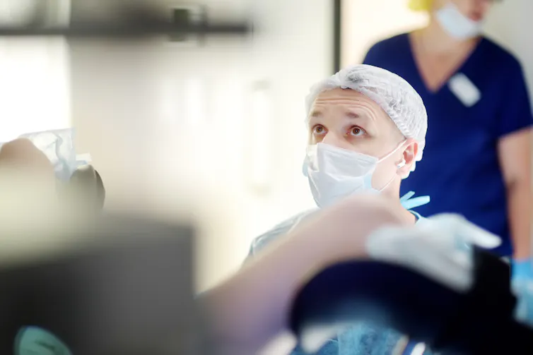Gynaecologist looks at a monitor.