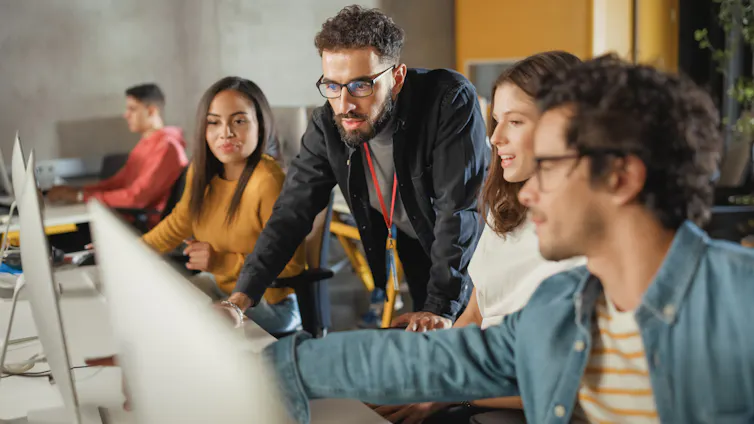 people discussing round a computer