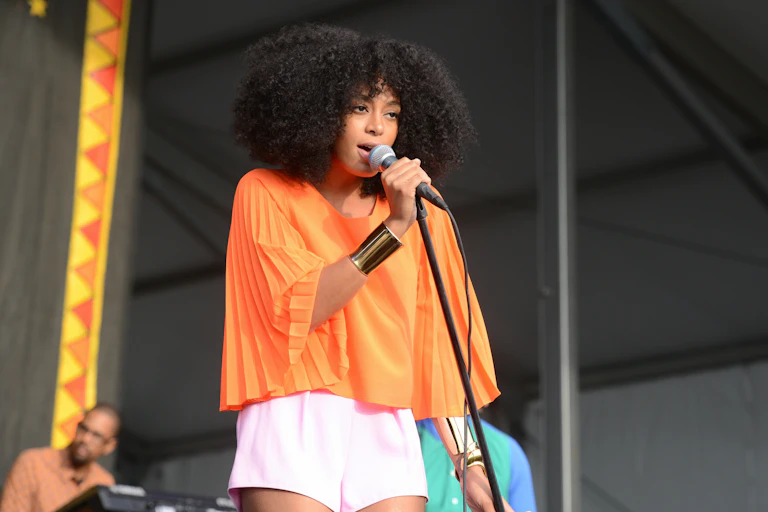 Solange Knowles sings on stage.
