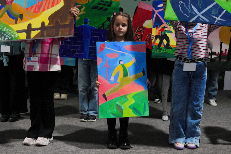 Young girl holds a painting