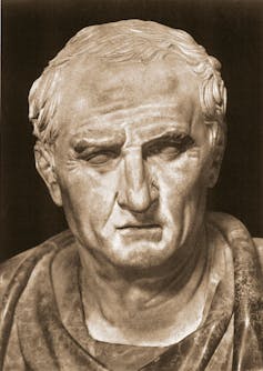Marble bust of bolding man with sharp features.