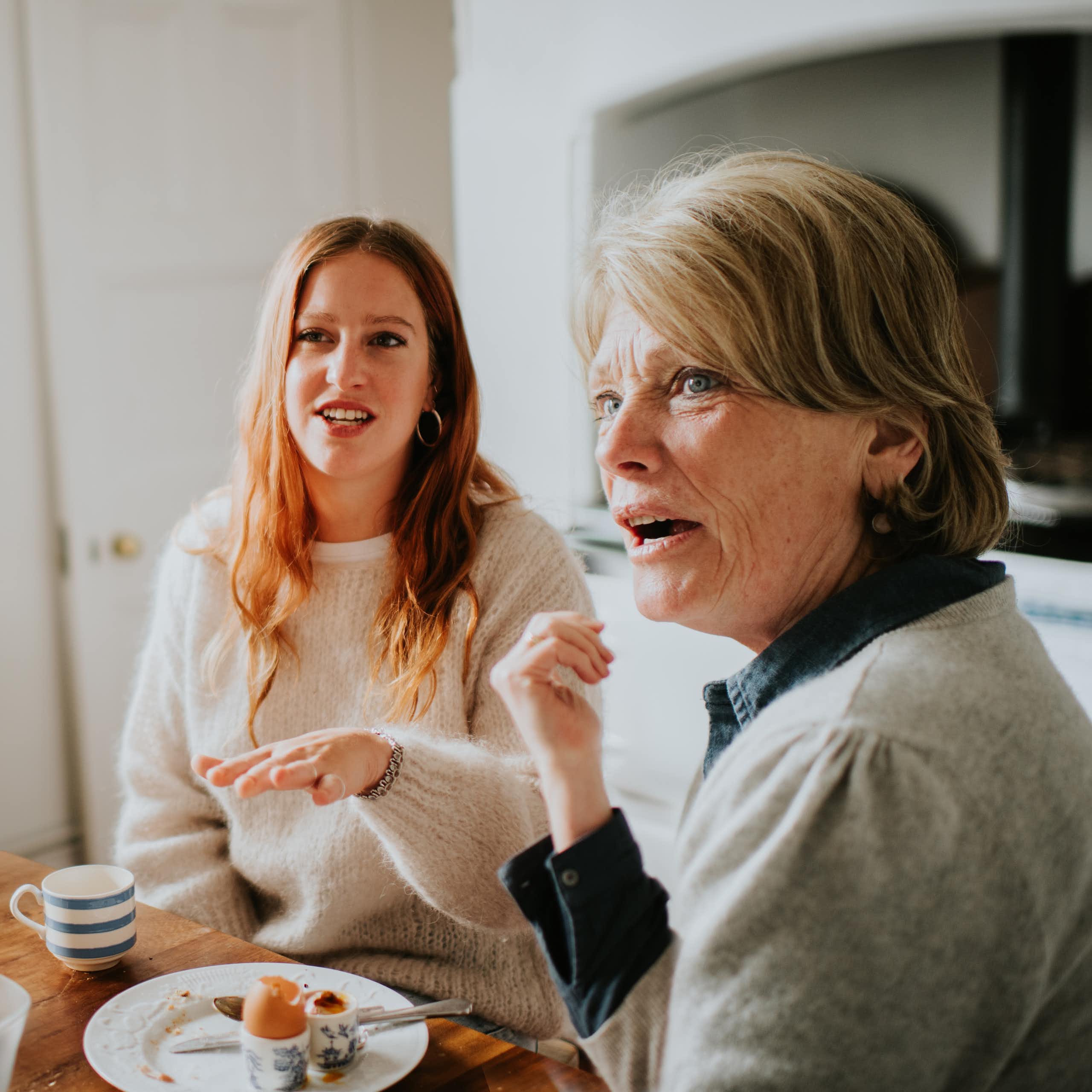 3 women at a kitchen table looking taken aback