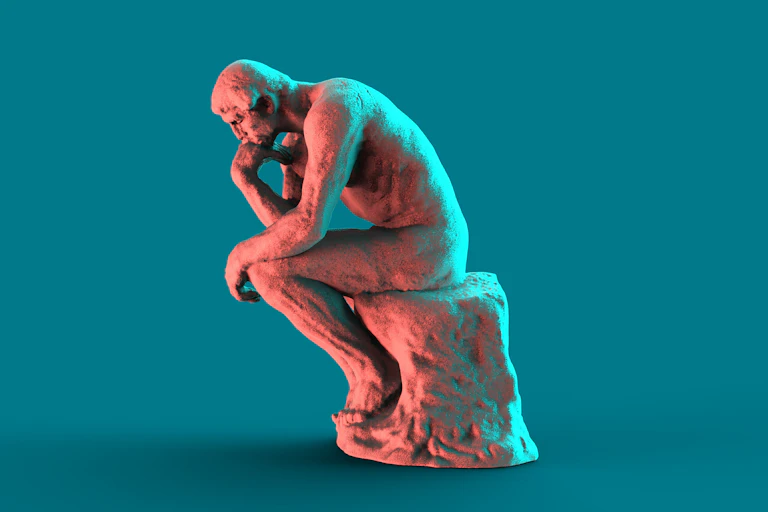 A copy of Rodin's sculpture 'The Thinker' set against a teal background.