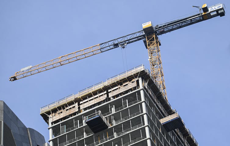 A construction crane above a building site.