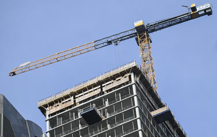 A construction crane above a building site.