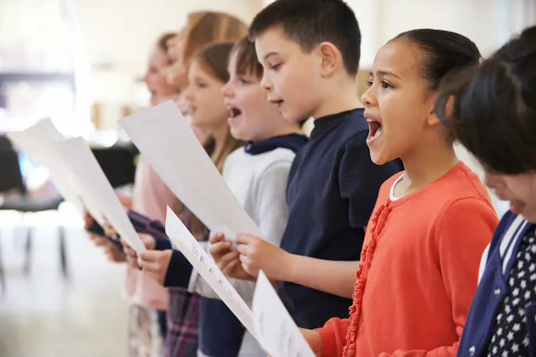 Young children sing.