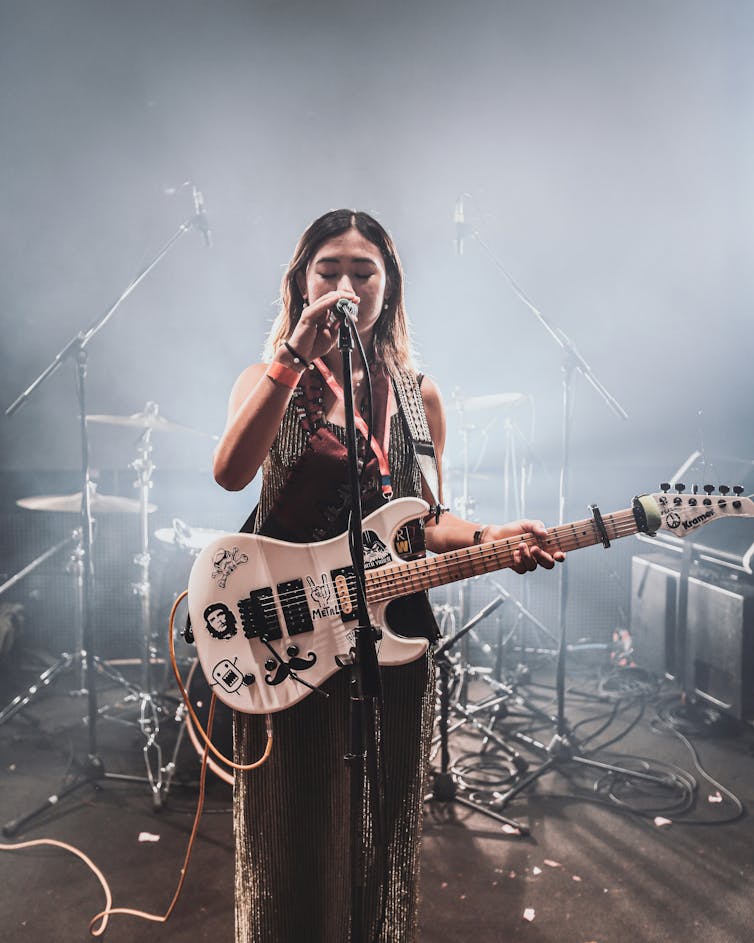 A woman with a guitar.