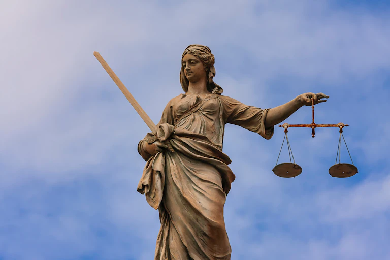 Statue of Lady Justice holding a sword and scales.