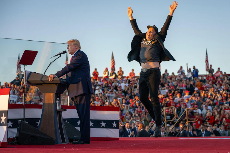 Donald Trump at a podium as Elon Musk cheers him on.