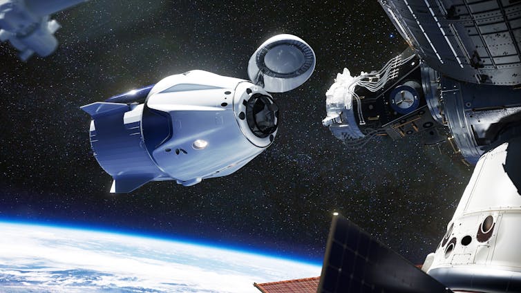 Space craft docking over Earth.