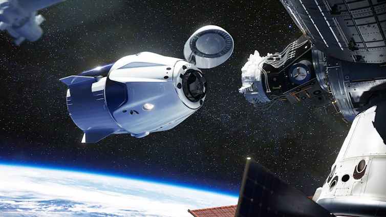 Space craft docking over Earth.