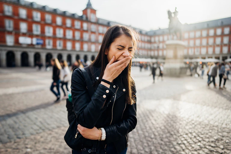 Woman yawning while on holiday in Madrid