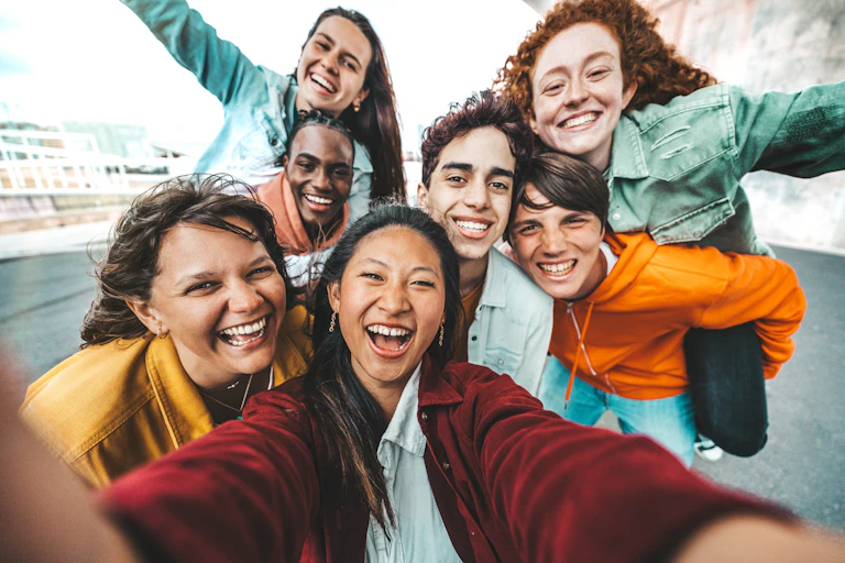 A group of smiling teens taking a selfie