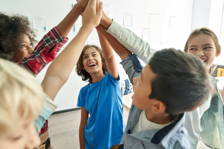 A group of grad-schoolers high-fiving
