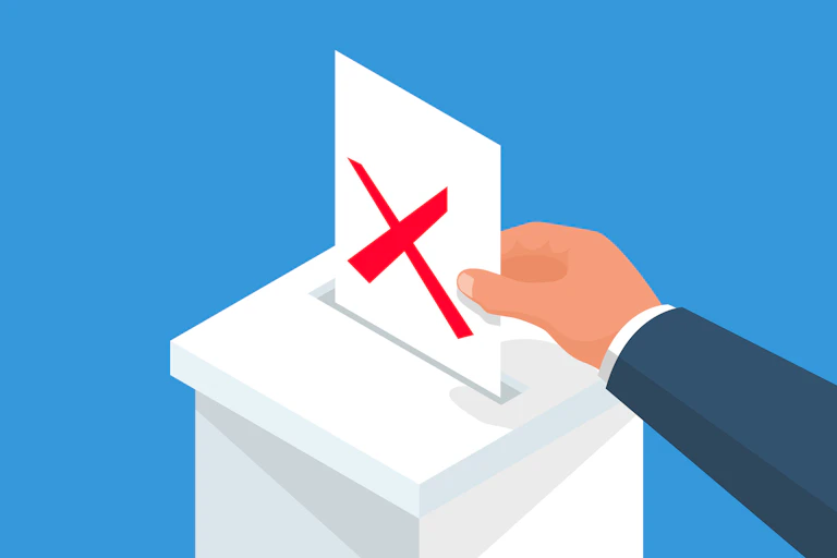 A man's hand putting a ballot marked 'X' in red into a box.