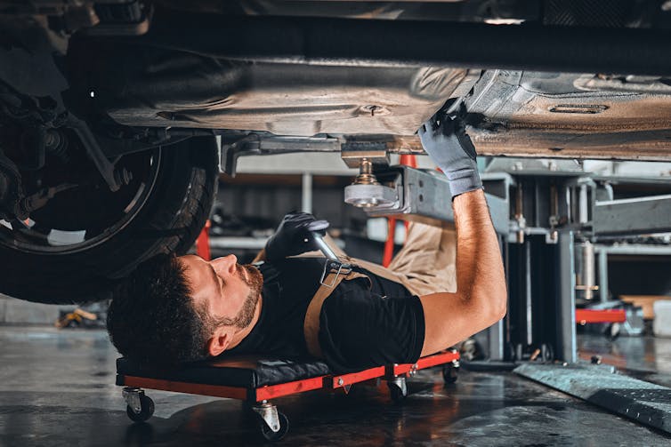 mechanic working under a car