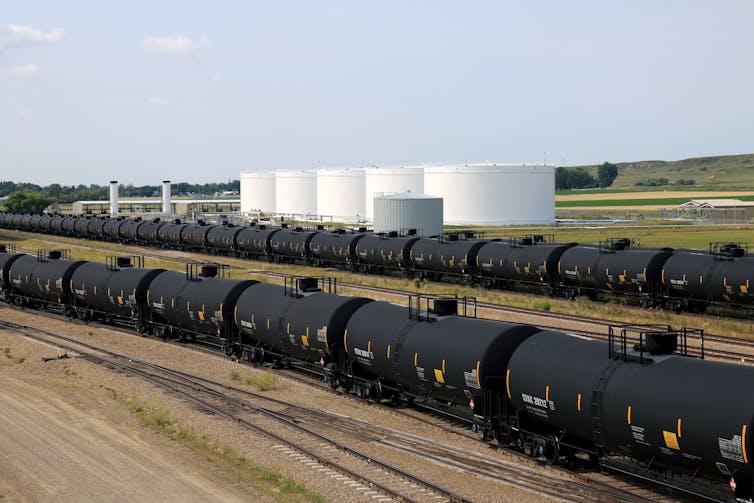 Long lines of oil tanker cars on a railroad siding.
