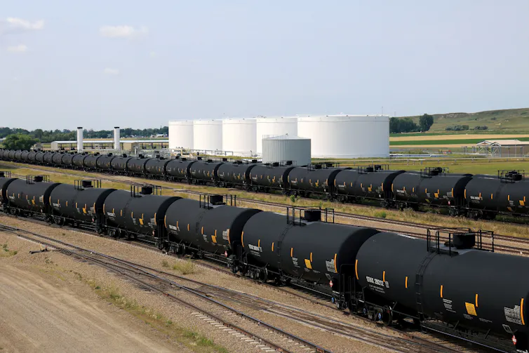 Long lines of oil tanker cars on a railroad siding.
