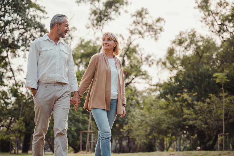 A middle-aged couple walking outdoors.