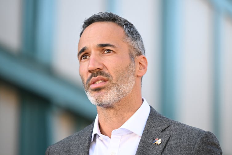 A man in a suit talks