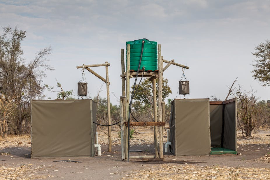 Eco-friendly outdoor showers with a bucket hung up high and linked to a water tank