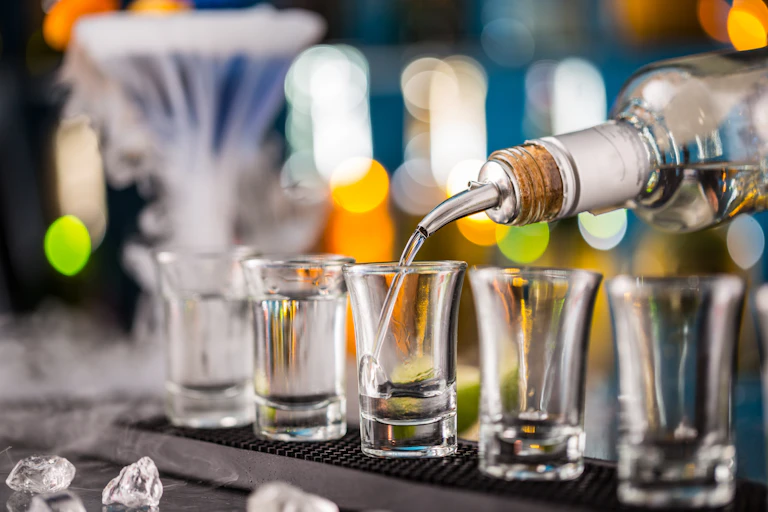 Shots being poured at a bar.