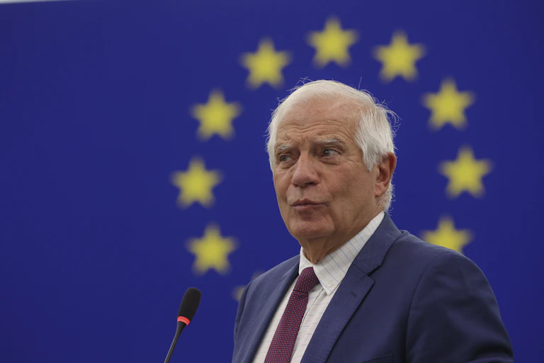 Josep Borrell delivering a speech against a a backdrop of the EU flag.