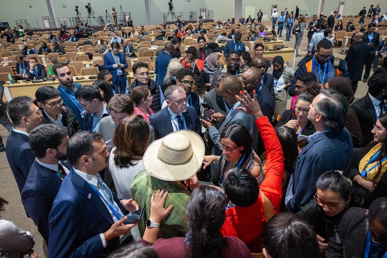 People in huddled together talking animatedly