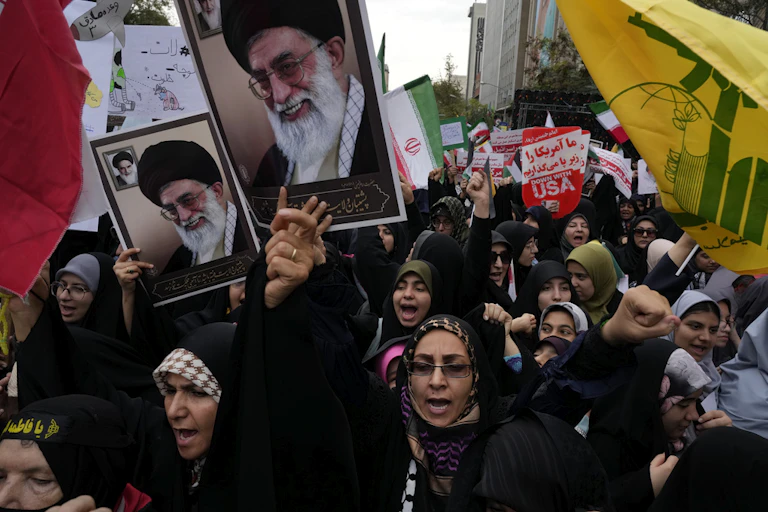 Demonstrators hold posters.